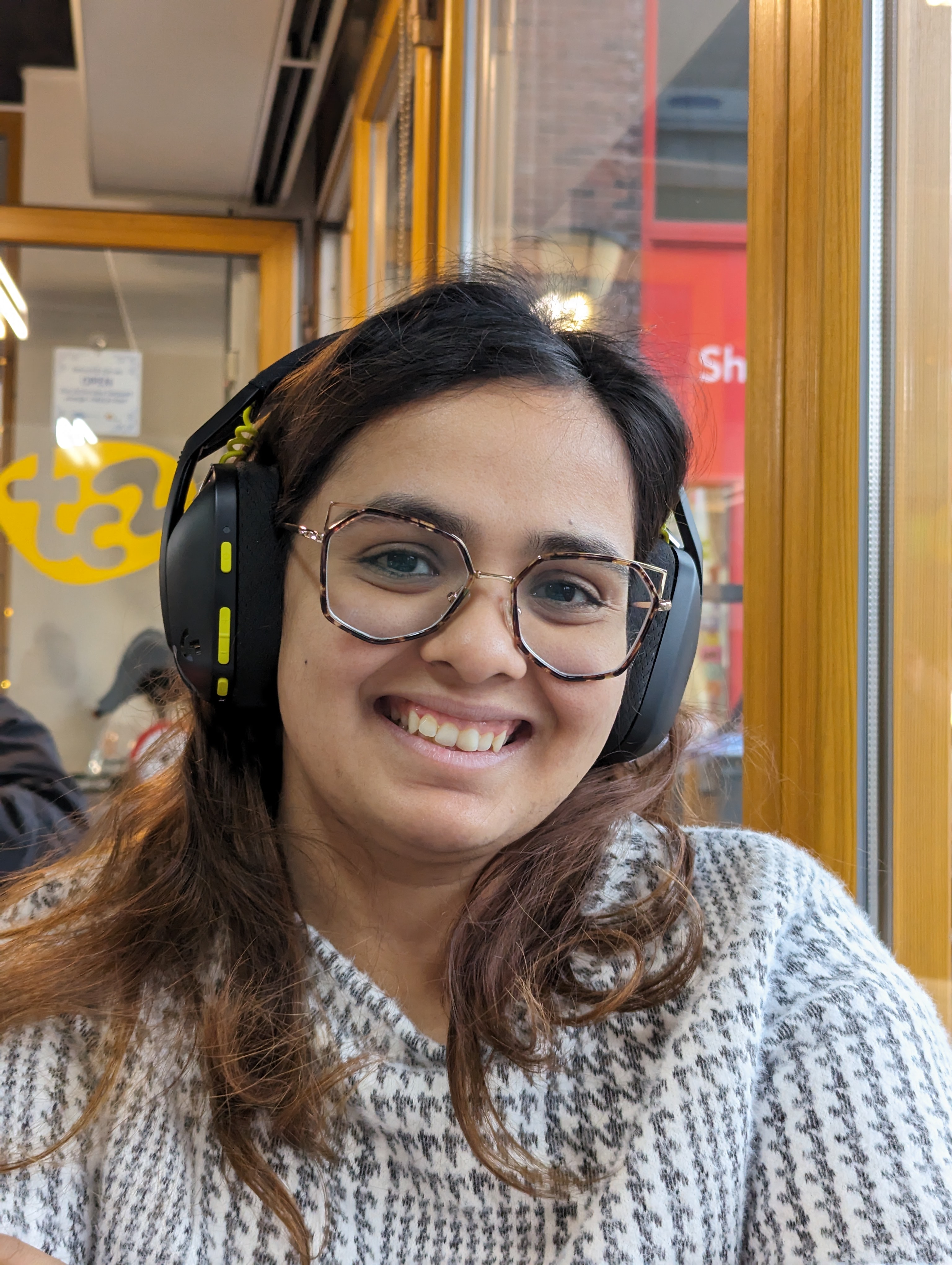 Candid picture of my wife, who is overjoyed at having stolen my phones, Nov 2023.